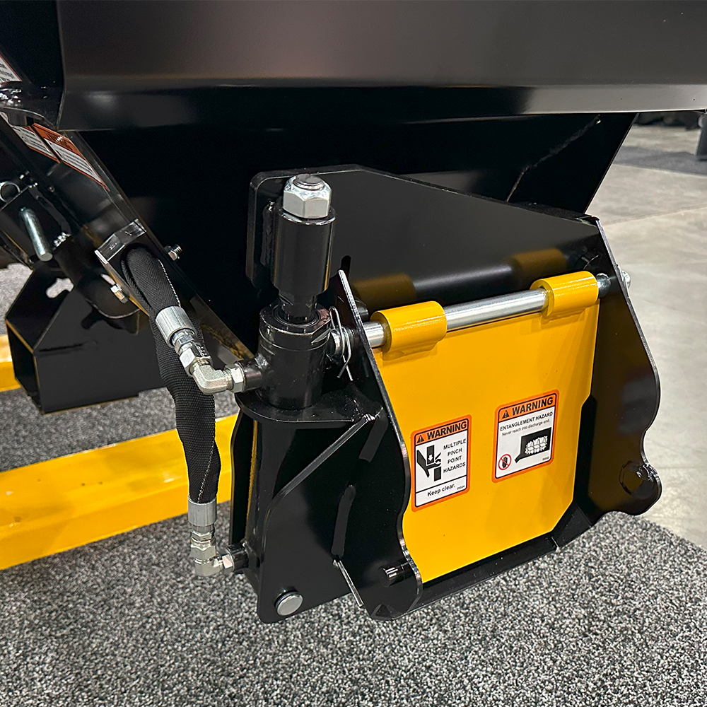 Image showing close-up of Danuser Mega Mixer hydraulic gate with hoses, fittings, and safety labels for pinch and entanglement risks