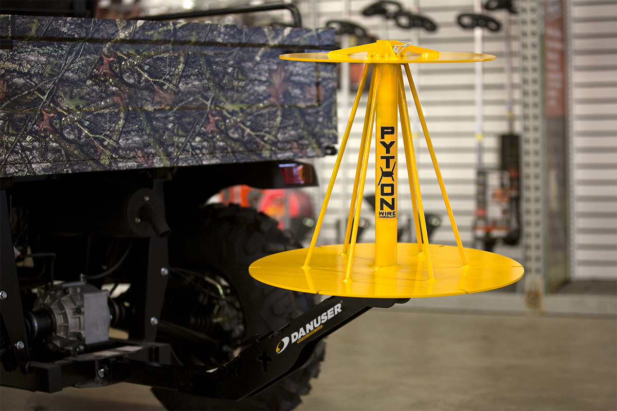 Image showing close-up of Danuser Python Wire Unroller on camo Bennche 4WD in store with tools and equipment in background