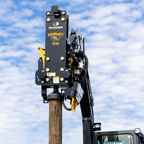 Hornet post driver attached to excavator
